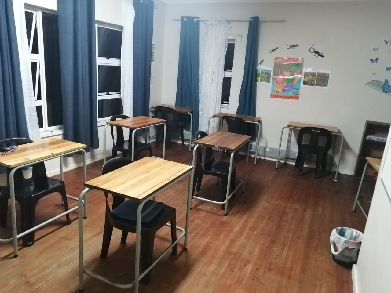 Bright classroom with wooden desks and educational materials