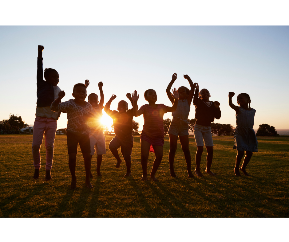Children jumping joyfully at sunset